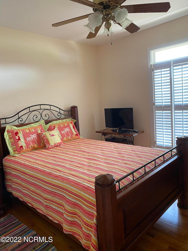 bedroom with ceiling fan and dark hardwood / wood-style flooring