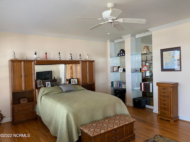 bedroom with wood-type flooring, ceiling fan, and crown molding