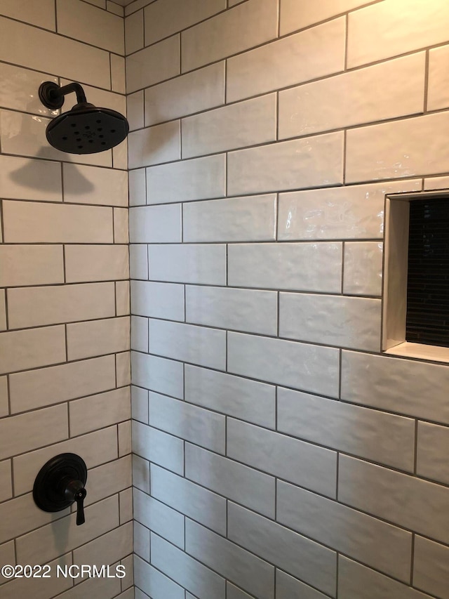 bathroom with a tile shower