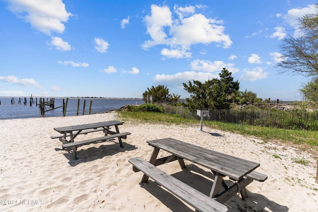 view of property's community with a dock and a water view