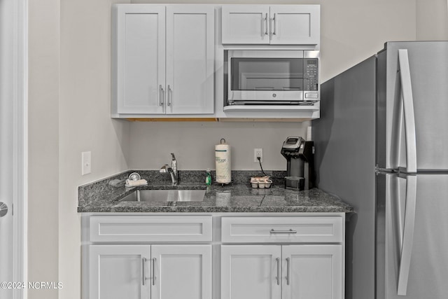 kitchen featuring sink, white cabinets, and appliances with stainless steel finishes