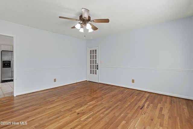 empty room featuring ceiling fan and light hardwood / wood-style flooring