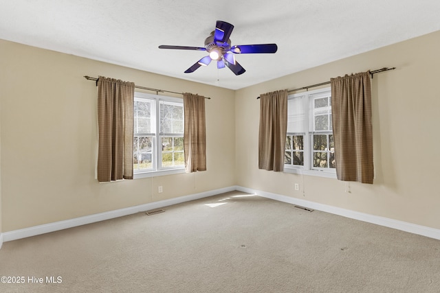 unfurnished room featuring ceiling fan and carpet