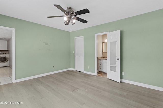 unfurnished bedroom featuring connected bathroom, washer / dryer, light hardwood / wood-style floors, and a closet