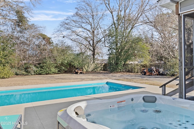 view of swimming pool with a hot tub