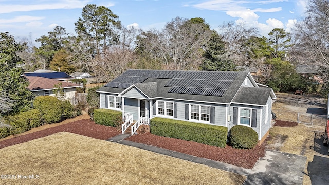 view of front of property featuring solar panels