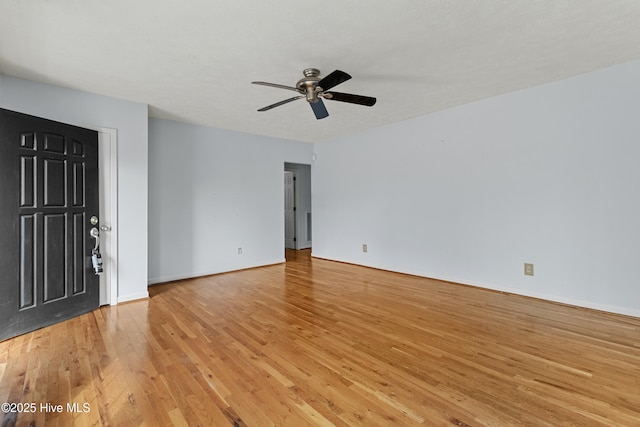 empty room with ceiling fan and light wood-type flooring