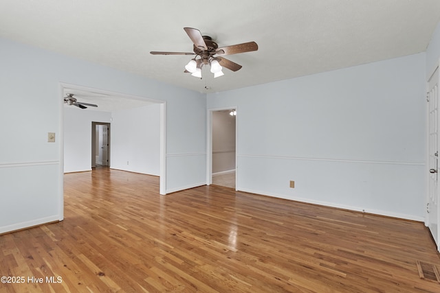 unfurnished room with hardwood / wood-style floors and ceiling fan