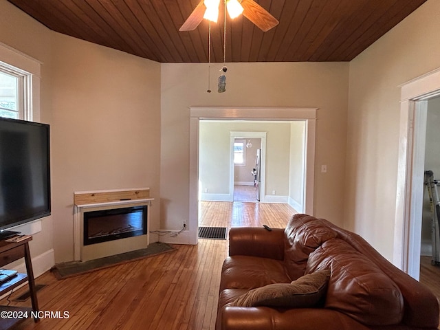 living room with hardwood / wood-style floors, ceiling fan, plenty of natural light, and wooden ceiling