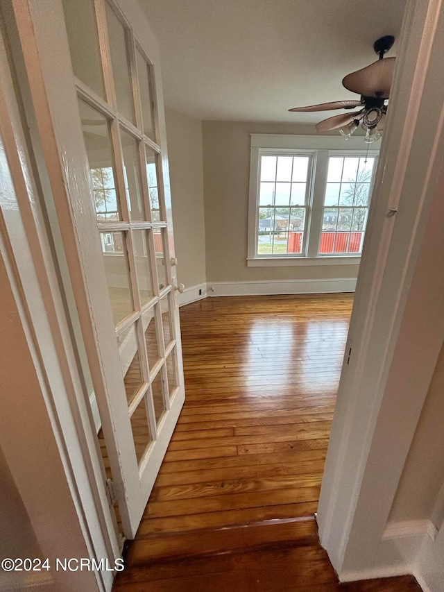 unfurnished room with hardwood / wood-style flooring and ceiling fan