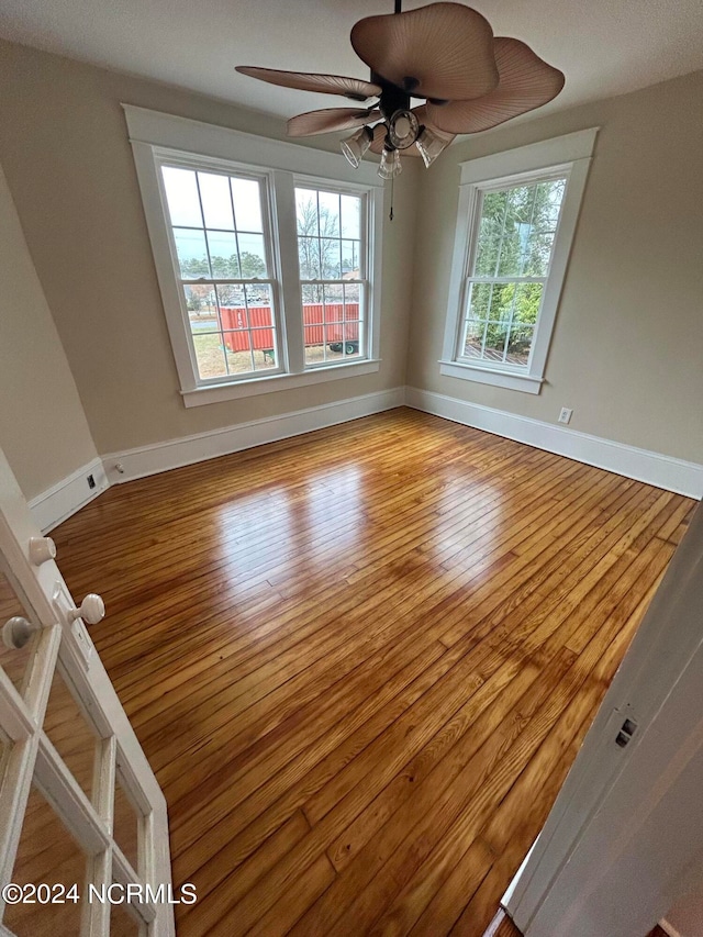 unfurnished room with ceiling fan and light wood-type flooring