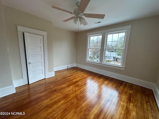 unfurnished room with hardwood / wood-style flooring and ceiling fan