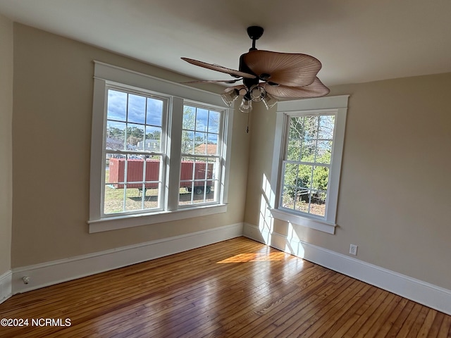 spare room with ceiling fan, plenty of natural light, and light hardwood / wood-style floors