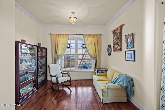 sitting room with dark hardwood / wood-style floors and ornamental molding