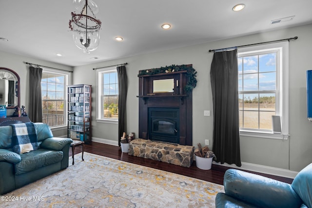 living room with plenty of natural light and dark wood-type flooring