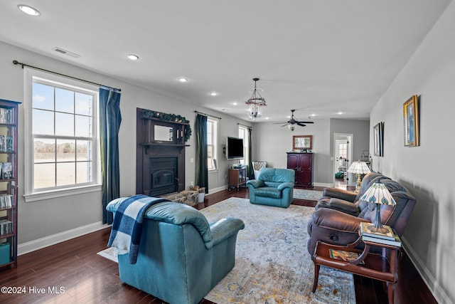 living room with ceiling fan and dark hardwood / wood-style floors