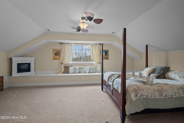 bedroom featuring ceiling fan, light colored carpet, and vaulted ceiling