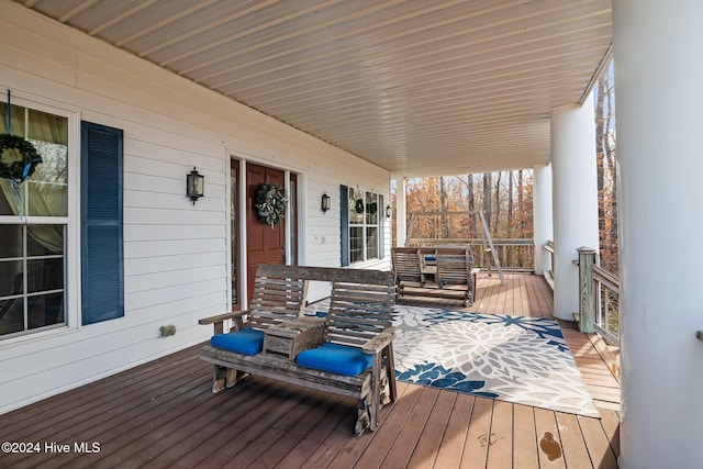 wooden terrace featuring covered porch