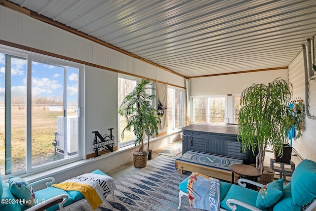 sunroom / solarium featuring a wealth of natural light and a hot tub