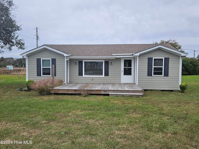 view of front of property featuring a front yard and a deck