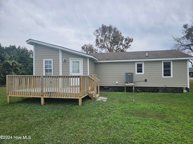 back of property with a lawn and a wooden deck