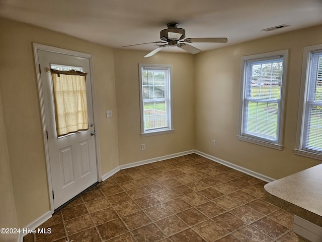 interior space with ceiling fan and a wealth of natural light