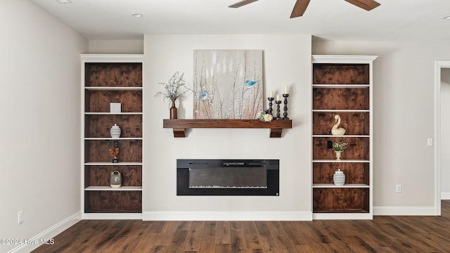 unfurnished living room featuring built in shelves, dark hardwood / wood-style flooring, and ceiling fan