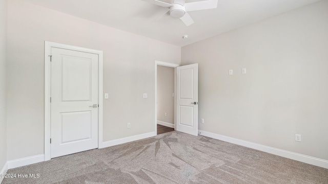 unfurnished bedroom with ceiling fan and light carpet