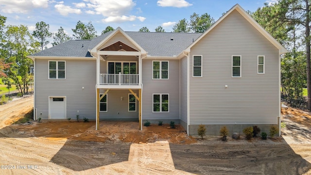 rear view of property featuring a balcony