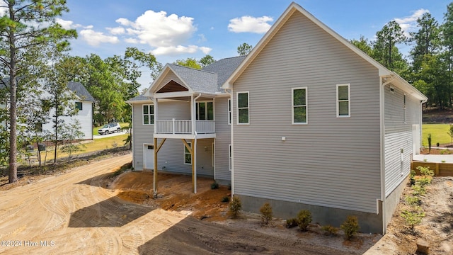 back of house featuring a balcony