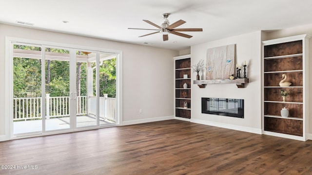 unfurnished living room featuring ceiling fan, a healthy amount of sunlight, and dark hardwood / wood-style floors