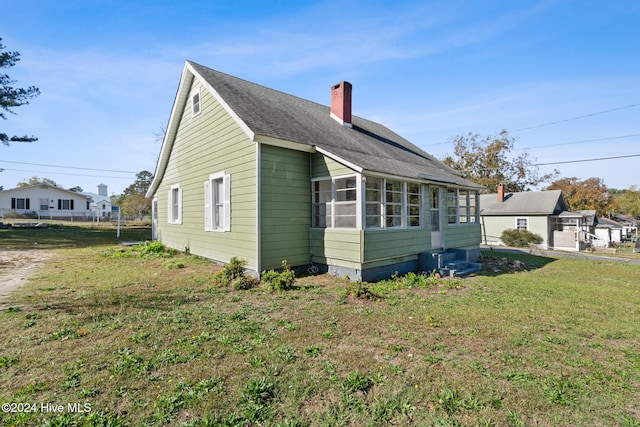 view of side of home with a lawn