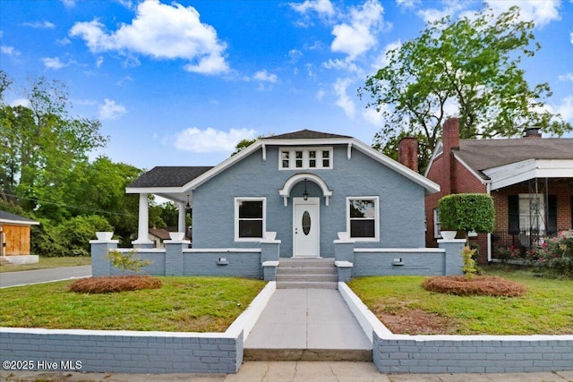 bungalow-style house with a front lawn