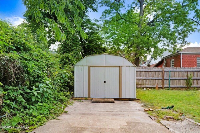 view of shed featuring fence