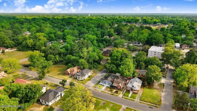 birds eye view of property featuring a residential view and a wooded view