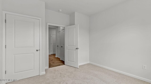 unfurnished bedroom with light carpet