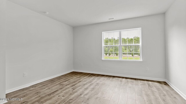 unfurnished room with light wood-type flooring