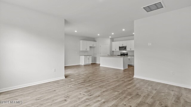 unfurnished living room with light hardwood / wood-style floors