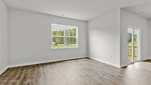 spare room with hardwood / wood-style floors