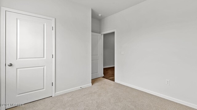 unfurnished bedroom with light carpet