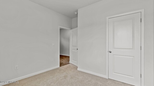 unfurnished bedroom with light colored carpet