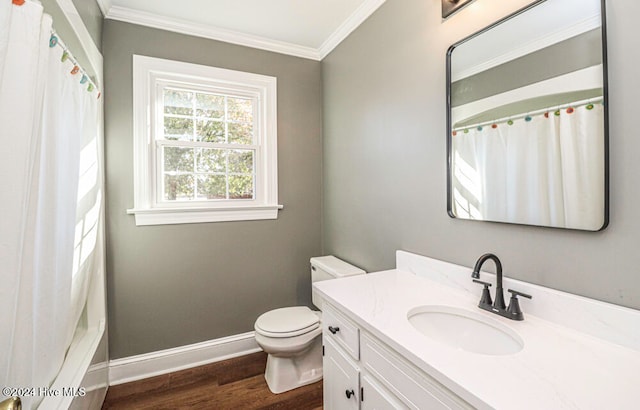 bathroom featuring toilet, hardwood / wood-style floors, vanity, and ornamental molding