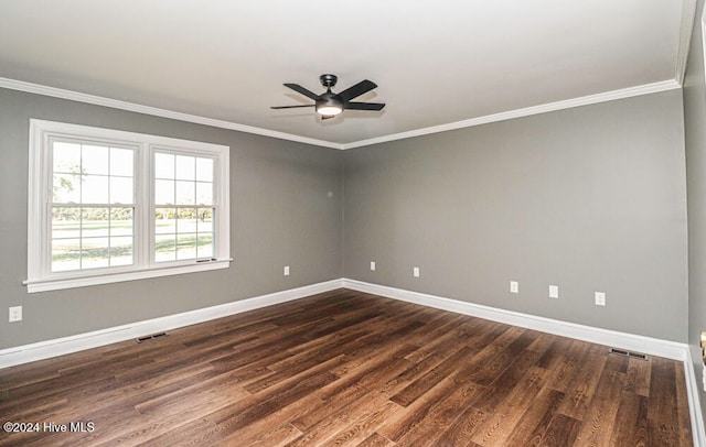 spare room with ceiling fan, crown molding, and dark wood-type flooring