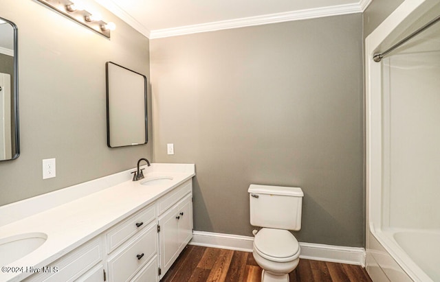 bathroom featuring vanity, hardwood / wood-style flooring, toilet, and crown molding