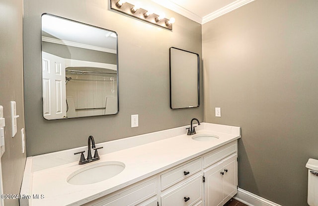 bathroom featuring vanity, toilet, and crown molding