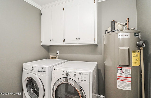 clothes washing area with cabinets, washing machine and clothes dryer, crown molding, and water heater