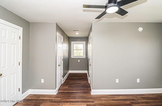 corridor with dark wood-type flooring