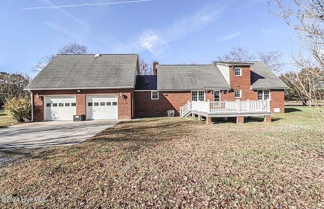 view of front of property featuring a garage, a front yard, and a deck