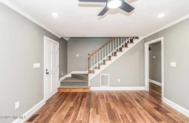 foyer with ceiling fan, dark hardwood / wood-style flooring, and ornamental molding