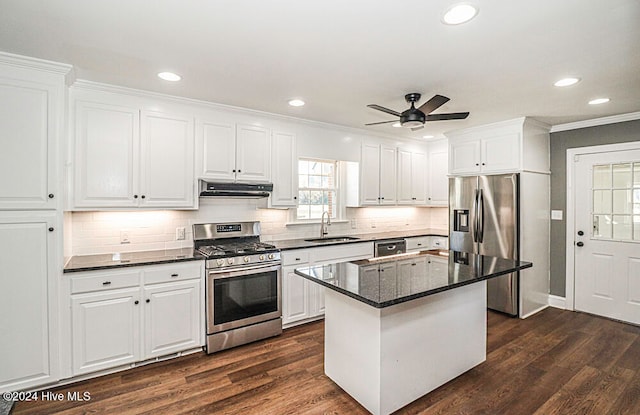 kitchen featuring white cabinets, a center island, stainless steel appliances, and sink